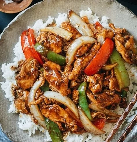 Delicious Black Pepper Chicken served on a plate with vegetables.