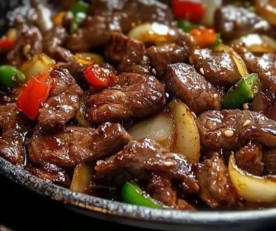Sizzling Chinese Pepper Steak with Onions served on a plate